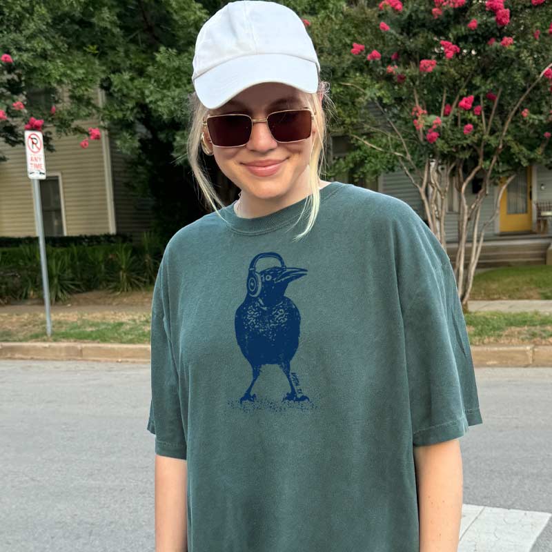 Beats Austin T-shirt, design is grackle wearing headphones, Comfort Colors 1717 Blue Spruce tee