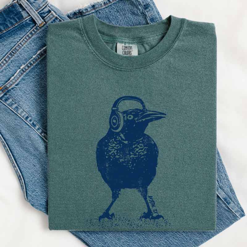 Beats Austin T-shirt, design is grackle wearing headphones, Comfort Colors 1717 Blue Spruce tee